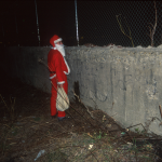 Santas in NYC -Santa Peeing in Manhattan - photo Harrod Blank