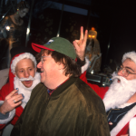 Santas in NYC -Michael Moore with Santas in NYC - photo Harrod Blank